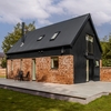Black Plastisol Corrugated Roof Sheets Fitted To A Brick House